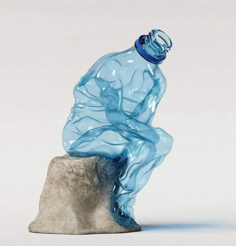 Compressed blue PET bottle on a stone pedestal, illustrating PET recycling